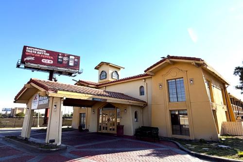 a building with a sign in front of it at Townhouse Garden Inn & Suites San Antonio I 35 in San Antonio