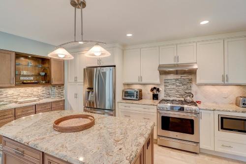 a kitchen with white cabinets and a granite counter top at Fairway Oasis in Hilton Head Island
