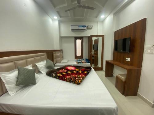 a bedroom with two beds and a television in it at Sonu luxury residency hotel in Amritsar
