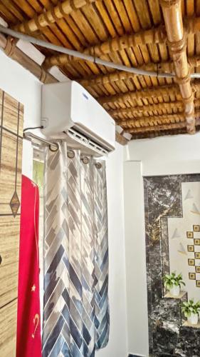 a kitchen with a stove top oven next to a wall at SERENITY BAY HOME 2bhk in Pondicherry