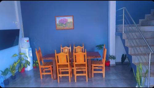 a dining room with a table and chairs at Teresita Boutique Home in Puerto Iguazú