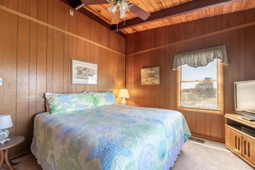 a bedroom with a bed and a television at Sun Byrne - K1060 in Whalebone