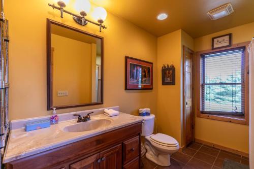 a bathroom with a sink and a toilet and a mirror at Blessed Sunset Getaway in Fleetwood