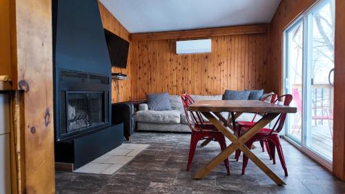 a living room with a table and a fireplace at Winter at Wildwood in Bailieboro