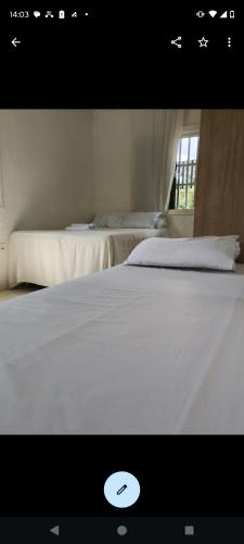 two white beds in a room with a window at Casa Cop 30 Belém in Belém