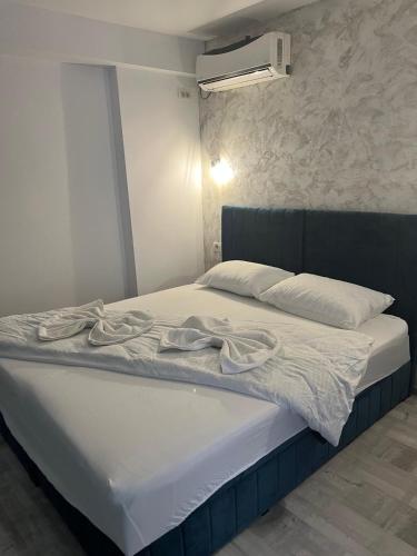 a bed with white sheets and towels on it at Ama 29 in Constanţa