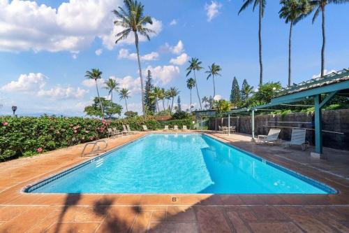 a large swimming pool with palm trees in the background at International Colony Club 23 · ICC 23 3BD Kaanapali Plantation C in Lahaina