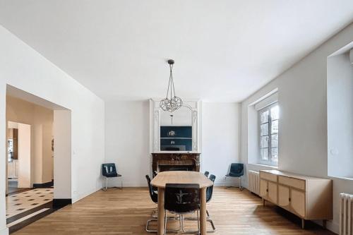 a dining room with a table and chairs at Stunning 230m with garden in the city center in Caen