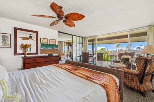a bedroom with a bed and a ceiling fan at Eldorado E204 · EL E204 Lanai with View Pool AC Beach Cabana Gym in Kaanapali
