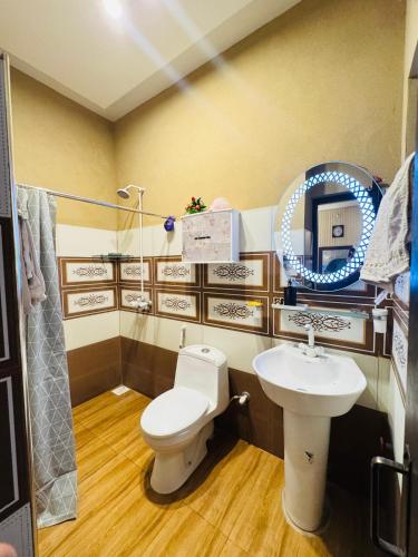 a bathroom with a toilet and a sink at The Comfy Cottages in Faisalabad