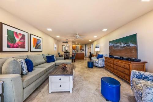 a living room with a couch and a tv at Eldorado E102 · EL E102 Quiet Condo w Lanai AC Beach Cabana Gym in Kaanapali