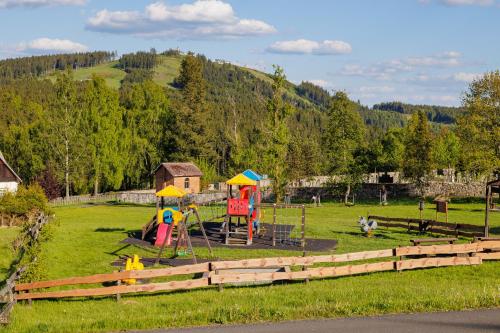 a park with children playing on a playground at Chalupa Andrea in Abertamy
