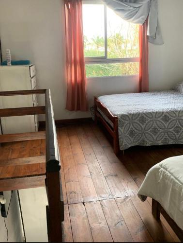 a bedroom with two beds and a window at Disfrutá tu estadía en Romana Dolores a solo 10 cuadras del parque termal Conseguí un ahorro exclusivo para el parque in Dolores