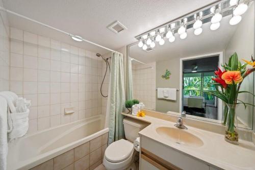 a bathroom with a sink and a tub and a toilet at Maui Banyan H207 · MB H207 Maui Escape Near Beach, Pool & Hot Tu in Kihei