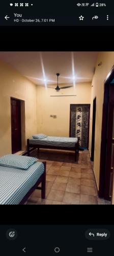 a room with two beds in a room at SMK homestay in Rāmeswaram