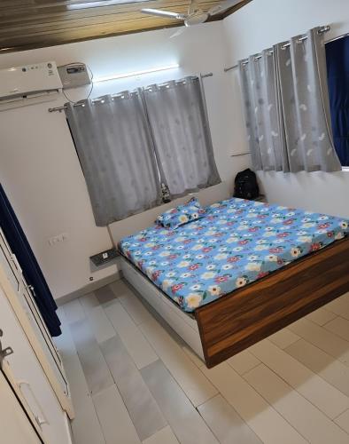 a bedroom with a bed in a room at H M farm in Surajpur