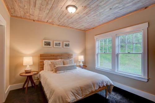 a bedroom with a bed and a window at Orchard House in Banner Elk