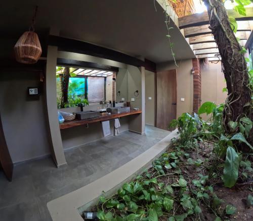 an open bathroom with two sinks and a tree at Casa A'more in Cuatunalco