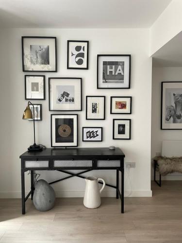 a black desk in a room with pictures on the wall at The Cambria in Ipswich
