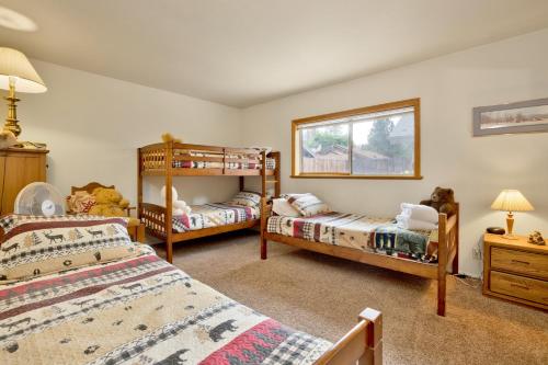 a bedroom with two bunk beds and a window at Idle hours inn #1945 in Big Bear City