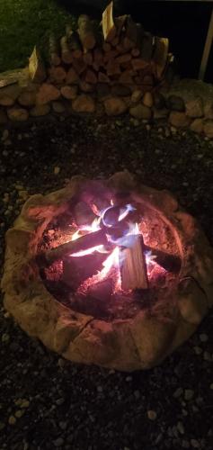 a fire pit with a bunch of lights in it at Vilat Pllumaj in Gropat e Selcës