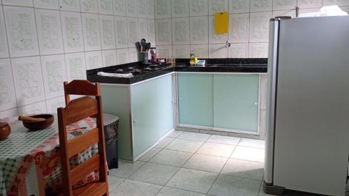 a kitchen with a sink and a refrigerator at Casa da Ana in Ananindeua