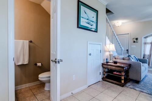 a living room with a toilet and a staircase at 120 Beau Clair - Beachview Townhome with Balcony and Deck in Long Beach in Long Beach