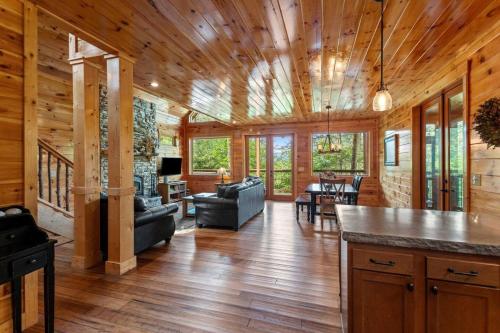 a large living room with wooden walls and wood floors at Hot Tub & WiFi - Sky Pointe - LUX cabin in RRG KY in Rogers