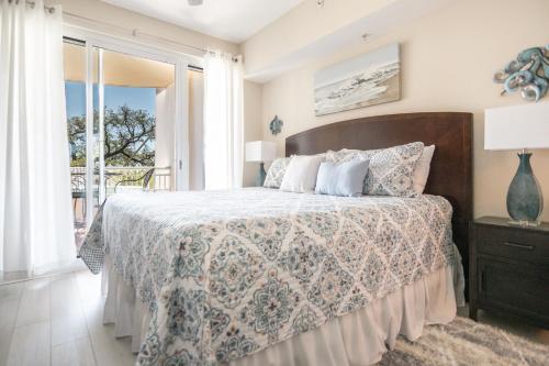 a bedroom with a bed and a balcony at Beachview Condo at Legacy Tower 2 -206 - fully furnished 2 bedroom 2 bathroom in De Buys