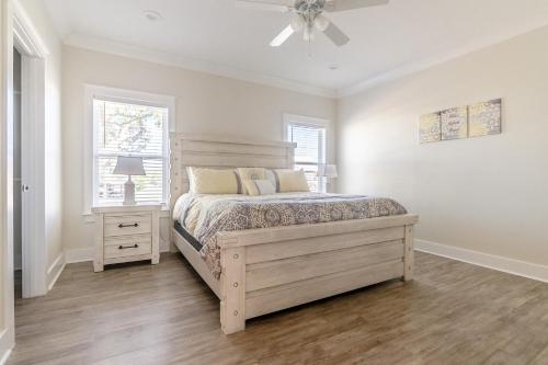 a bedroom with a bed and a ceiling fan at Brand New Home with Beach Views! Fully furnished 3 bedroom home in Gulfport in Gulfport