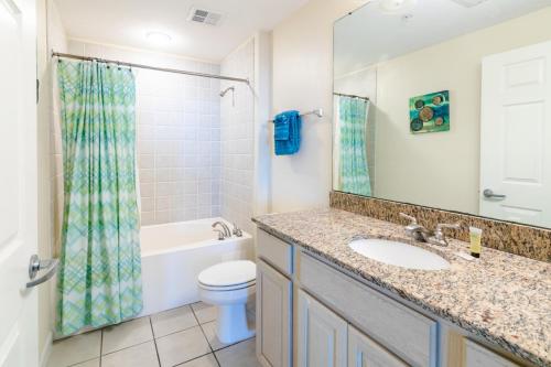 a bathroom with a sink and a toilet at Beachview Condo at Legacy Tower 2 -706 - fully furnished 2 bedroom 2 bathroom in De Buys