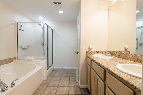 ein Badezimmer mit Badewanne, Waschbecken und Dusche in der Unterkunft Beachview Condo in Legacy Tower 1 -603 - fully furnished 3 bedroom 2 bathroom in De Buys