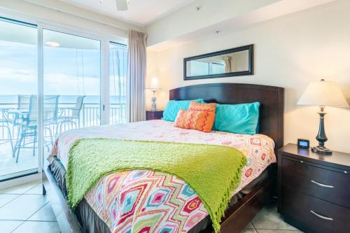 a bedroom with a bed with a view of the ocean at Beachview Condo at Legacy Tower 2 -706 - fully furnished 2 bedroom 2 bathroom in De Buys