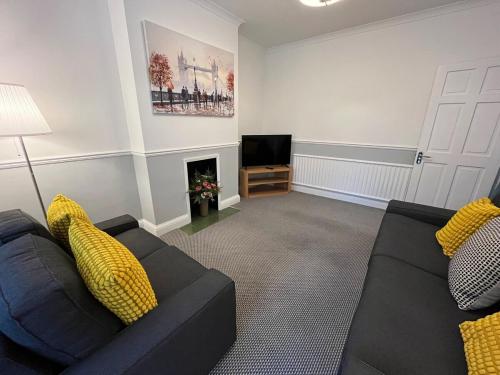 a living room with a couch and a television at Pitfold Road in London