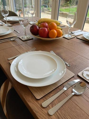 a wooden table with a plate of fruit on it at Pitfold Road in London