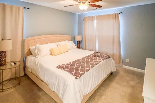 a bedroom with a bed and a ceiling fan at Waterfront condo at Harbor Landing G02 - Relax in BEAUTIFUL Ocean Springs in Gulf Park Estates