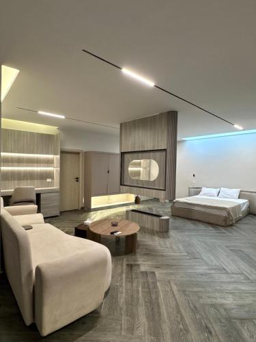 a hotel room with two beds and a couch at Hayah Inn Cairo - Rehab City in Cairo