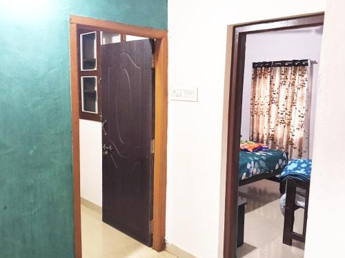 a room with a door and a room with a bed at Hegde Farmstay in Udupi