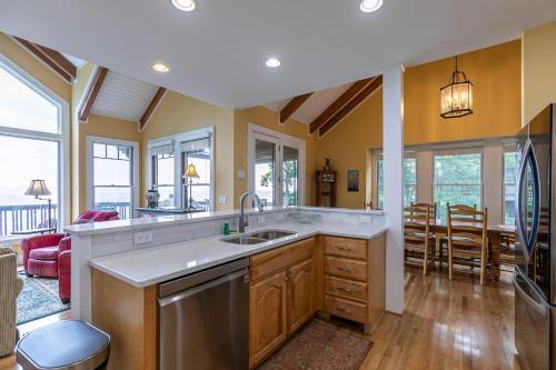 a kitchen with a sink and a living room at Echota Ridge Boulders in Banner Elk