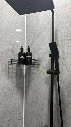 a black lamp and a microphone on a stand at Новое ЖК in Semey