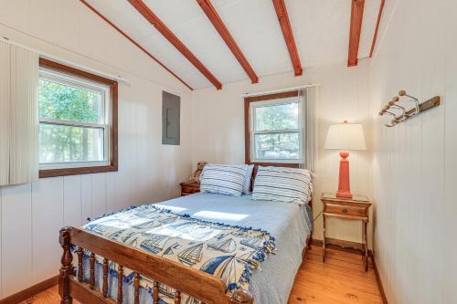 a bedroom with a bed and two windows at Clarks Hill Lake Retreat! Waterfront Home with Dock in Clarks Hill