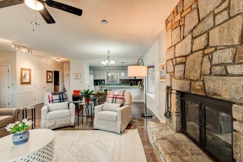 a living room with a stone fireplace at Chetola: Robin 1 in Blowing Rock