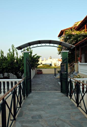 an entrance to a building with a green gate at Hotel Athena in Kokkari
