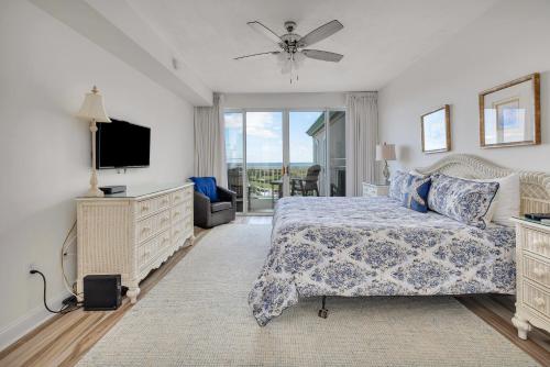 a bedroom with a bed and a flat screen tv at St. Simons Grand #305 in Saint Simons Island