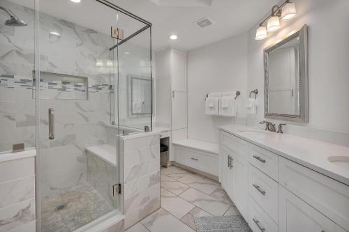 a white bathroom with a shower and a sink at St. Simons Grand #305 in Saint Simons Island