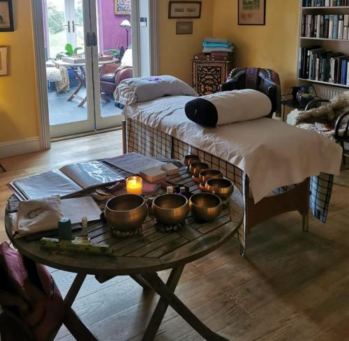 a room with a table with bowls and candles on it at Kilmokea Garden Suite in New Ross