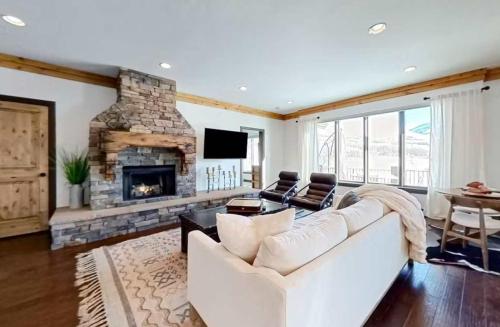 a living room with a white couch and a fireplace at Wild Horse Meadows Eden Powder Mtn in Wolf Star