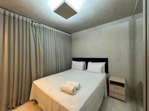 a bedroom with a bed with a towel on it at iFlat Lozandes Flamboyant Jardim Goiás in Goiânia