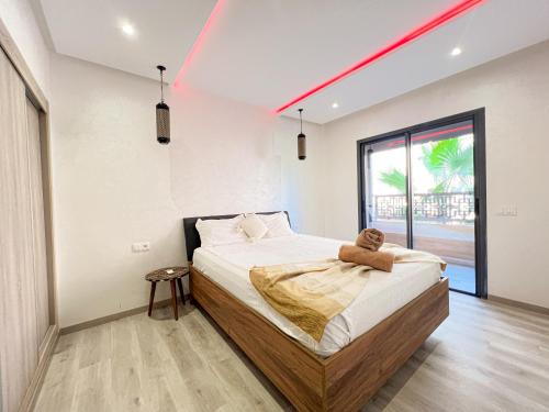 a bedroom with a bed with a teddy bear on it at Condo in marrakech with pool in Marrakesh