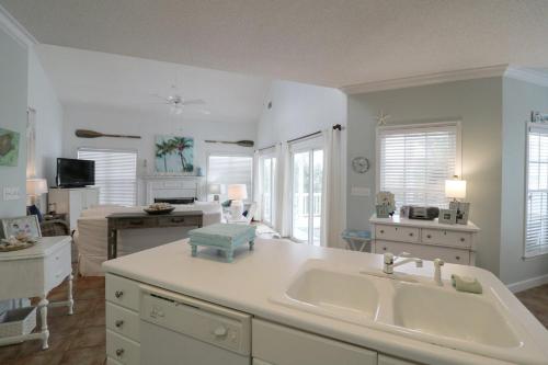 a kitchen with a sink and a living room at #3 B 18th Place in Tybee Island